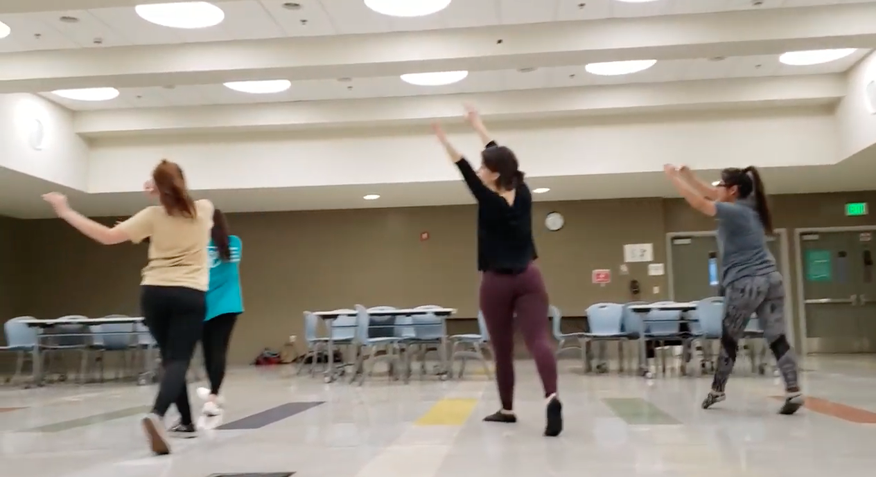 Teens taking dance class indoors